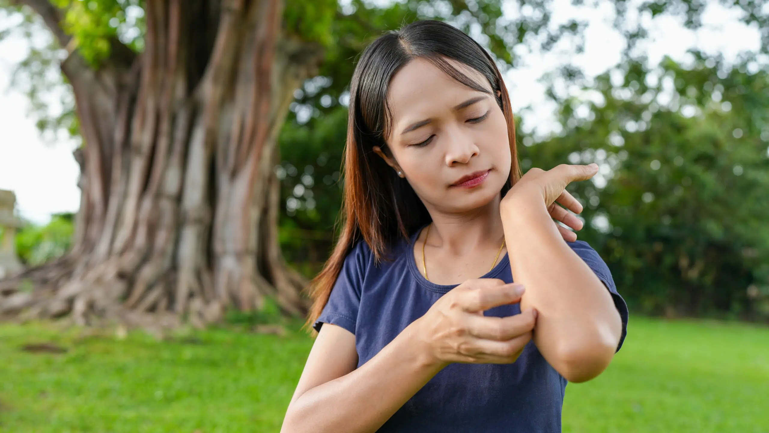 Woman in a country area scratching eczema prone skin